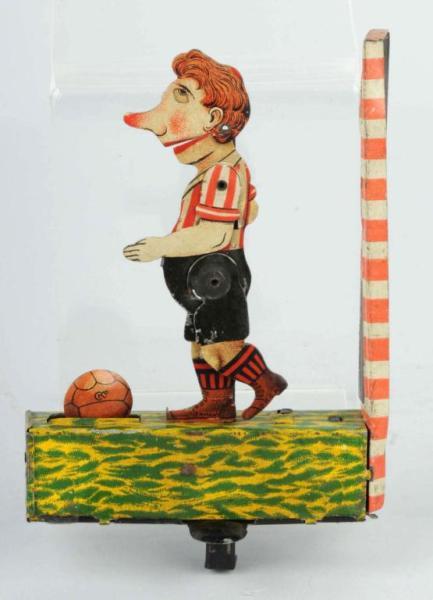 Tin Litho Soccer Handheld Toy.: German. Marked "CKO". Nice lithography. When plunger is pushed on bottom, player appears to kick ball. Size: 5 - 1/2" T.