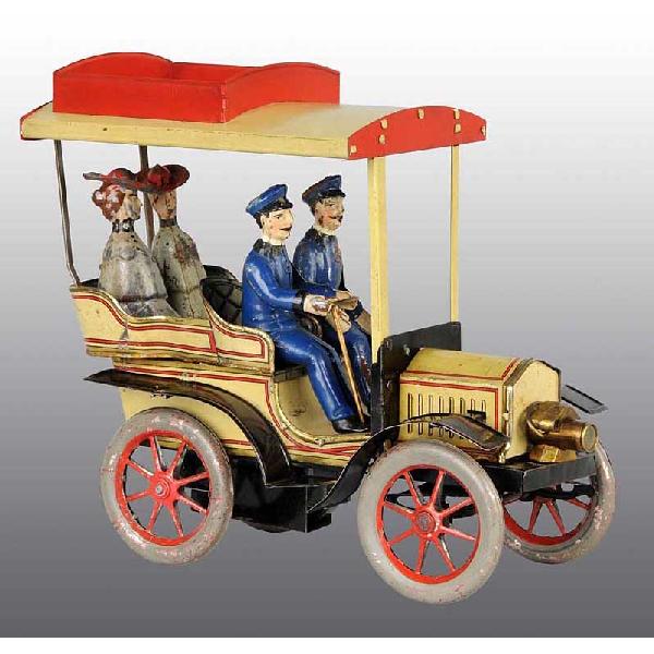 Tin Carette Automobile Clockwork Toy.: German. Circa 1912. Working. Includes four full-bodied tin figures, two men and two women. Replacement roof and roof rack. Some scratching and wear throughout. Size: 9" L.