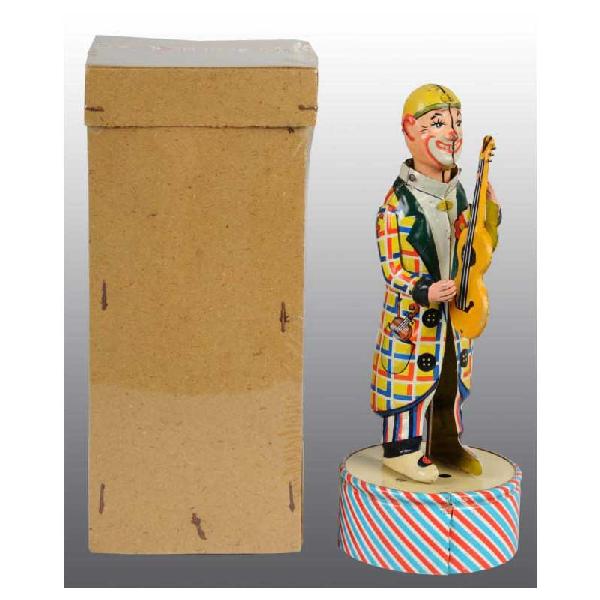 Tin Distler Guitar Player Wind-Up Toy.: German. Working. Nice tin lithography. When wound, plays plink-plink music and clown figure moves his head back and forth while arm moves to simulate guitar playing. Some minor scratching and wear. In