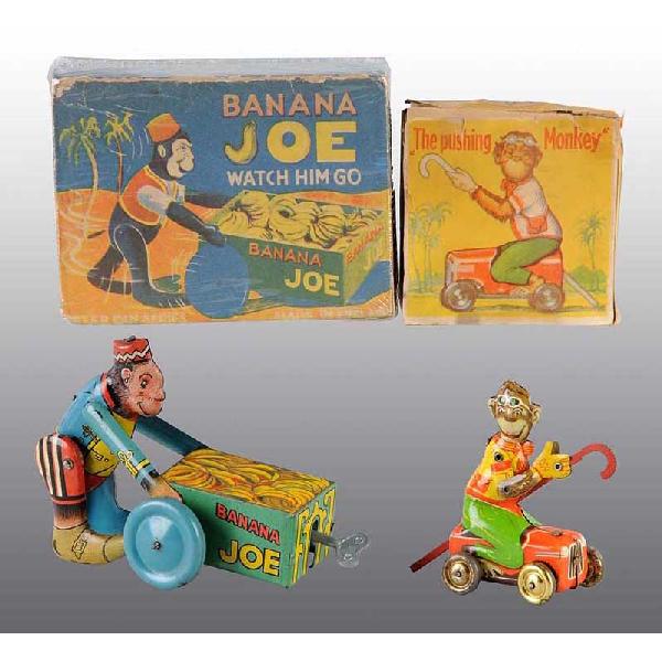 Lot of 2: Tin Litho Monkey Wind-Up Toys.: Working. Includes one English Banana Joe pushing cart and one German Monkey Cart propelled by a pushing a cane. Light scratching throughout. Includes both original boxes with nice color graphics and s