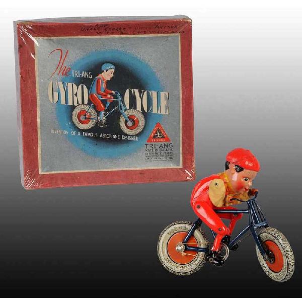 Tin & Celluloid Tri-ang Gyro Cycle Toy.: English. Working. Unusual mechanism. Frame of toy is metal, wheels are tin, and figure is celluloid. Includes original box with personal inscription on box. Size: 8 - 1/4" L.
