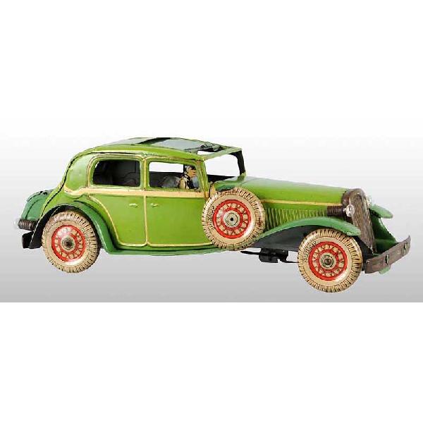 Tin Automobile Wind-Up Toy.: English. Working. Opening trunk and roof. Original lithographed driver and lithographed wheels marked "Dunlop". Car has some overall pitting of the metal, especially to fenders, front grille, wheels,