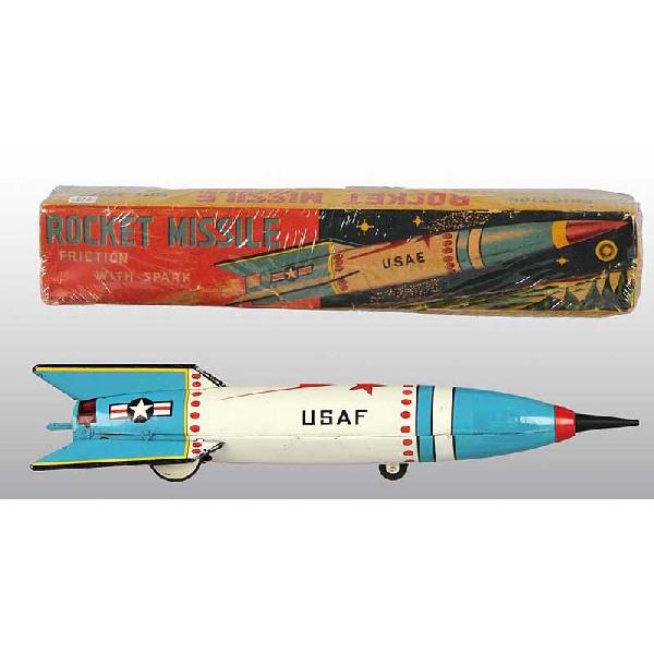 Tin Rocket Missile Friction Toy.: Japanese. Working but needs flint to spark. Marked "USAF" on side. Original rubber tip on front. A few spots of factory touchup to nose cone. Includes colorful original box with some creasing and slig