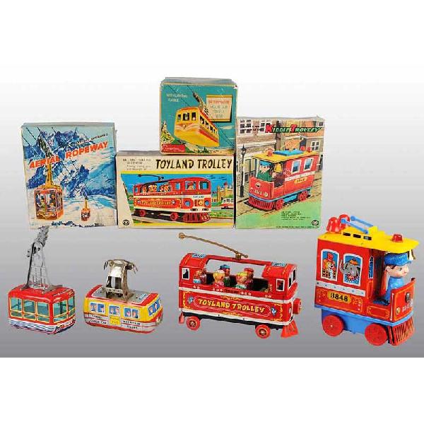 Lot of 4: Tin Vehicle Battery-Operated Toys.: Japanese. Working. Includes two trolleys and two cable cars. Nice lithography throughout. Includes all original boxes, one trolley box with original box inserts. Size: Largest: 12" L.