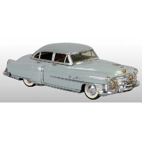 Tin Marusan Cadillac Friction Toy.: Japanese. Circa 1950s. Working. Marked "San" on bottom of car and "2203" on license plate. All original with very little wear and just minor scratching to roof. Pictured in Dale Kelley's "Collecting t