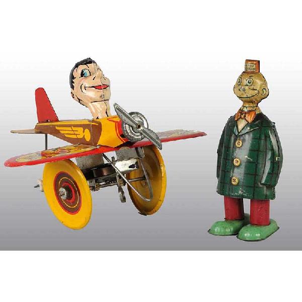 Lot of 2: Tin Character Wind-Up Toys.: American. Working. Includes one Chein Happy Hooligan walker toy marked "1932 King Features Synd.". and one Marx Rookie Pilot toy. Happy Hooligan has one dent to back of head and some overall scratchin