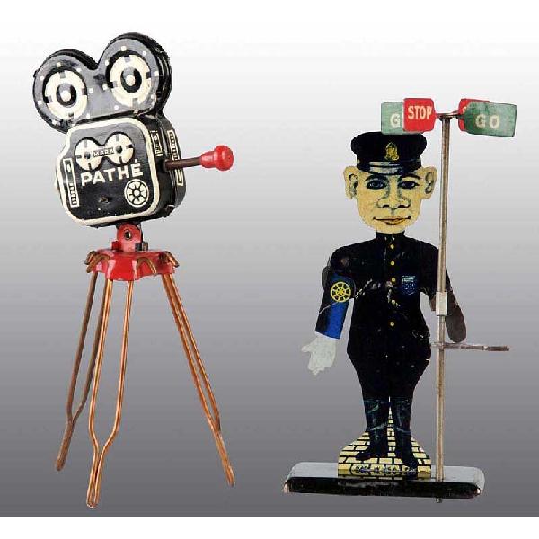Lot of 2: Early Tin Marx Toy Accessories.: American. Includes scarce PATHE camera on tripod and one policeman on stand with movable arms and stop and go sign. Light scratching and wear. Largest: 6" T.