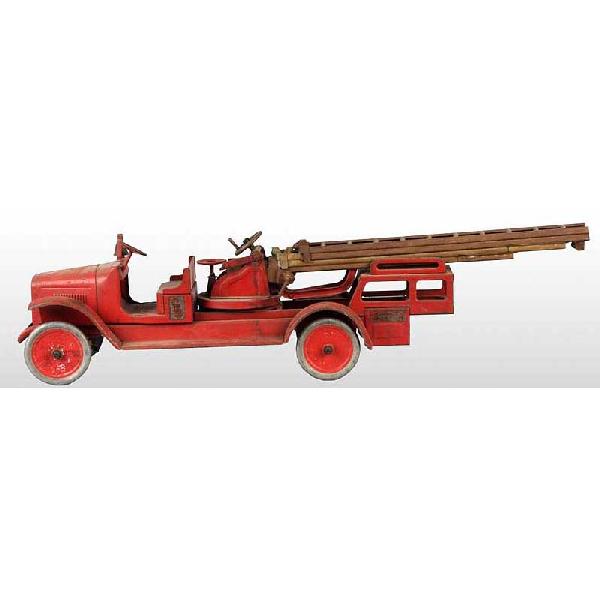 Pressed Steel Buddy L Aerial Fire Ladder Truck.: American. Partial decals on sides and Buddy L decal on front grille with slight chipping. Moderate overall paint loss and wear throughout. Ladders are original but have oxidation and rust. 38" L.