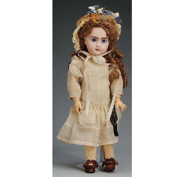 Jumeau French Bisque Bébé Doll.: Red checkmarks on back of head (completely repaired and repainted, but hairlines still somewhat visible), new paperweight eyes, open mouth with molded upper teeth, pierced ears, replaced wig, jointed 