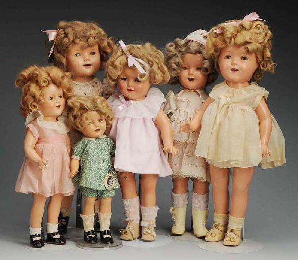 Lot of 6: Ideal Composition Shirley Temple Dolls.: 1930s. 1 repainted, 1 replaced wig, all with replaced clothing, all have some crazing and wear. Size: Largest: 20" T.