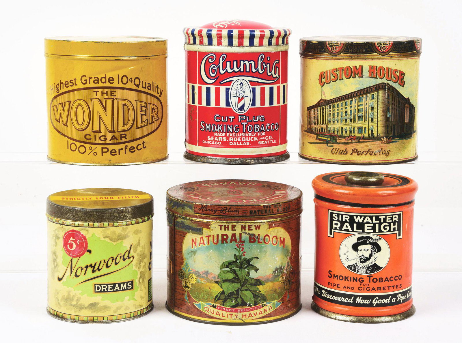 LOT OF 6: ROUND CIGAR TINS.: This is a lot of six round cigar tins. It includes a Norwood Dreams, a Natural Bloom, a Wonder, a Columbia, a Custom House and a Sir Walter Raleigh. The Sir Walter Raleigh and Columbia tins are tobacc