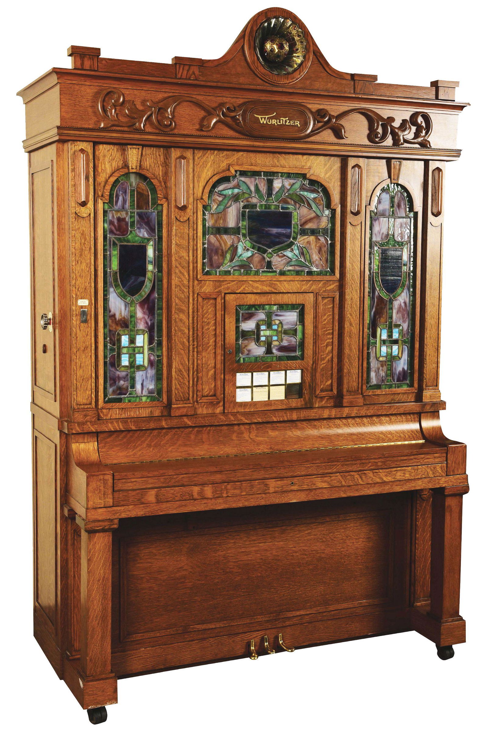 WURLITZER MODEL BX QUARTERED OAK ORCHESTRON.: An incredible Wurlitzer orchestrion, equipped to play flute pipes, piano, mandolin, triangle, and base and snare drums. In total, there are 76 pipes, and unlike any band organs of its time, this orche
