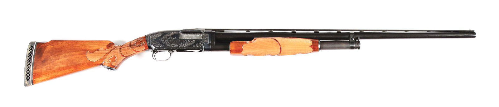 (C) WINCHESTER MODEL 12 SLIDE ACTION SHOTGUN ENGRAVED: Winchester Model 12 slide action shotgun with vent rib, front and mid bead sights on a serrated vent rib from Simmons Gun Specialties Inc, Kansas City, Missouri. 2-piece walnut forearm and buttstock c