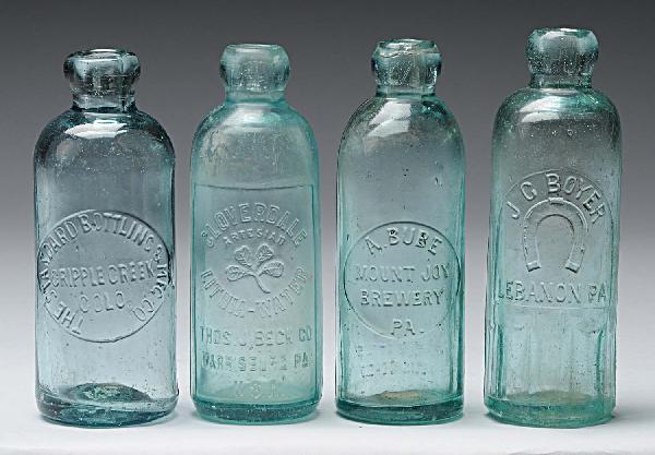 Lot of 4: Tinted Hutchinson Style Bottles.: All are green glass. Includes one marked "Cripple Creek Colorado", one "A. Bube", one "J.Z. Boyer", and one "Cloverdale Bottling Works". Size: Largest: 7" T.