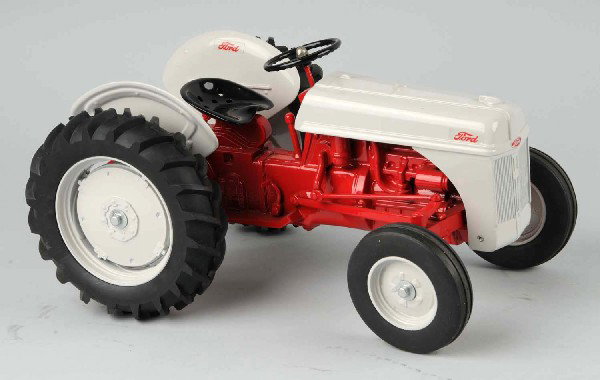 Metal Ford Tractor Toy.: With Ford logo on front and on shields over the wheels. Size: 13 - 1/2" L.