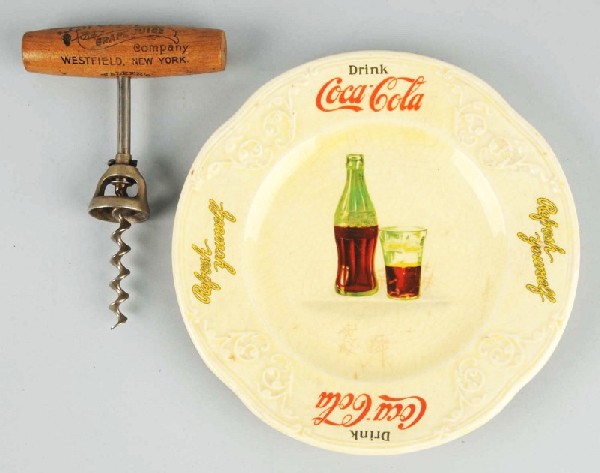 Lot of 2: Coca-Cola Items.: Description Includes Coca-Cola plate and Welch's Juice corkscrew. Condition (Near Mint). Size Largest: 7 - 1/4" Dia.