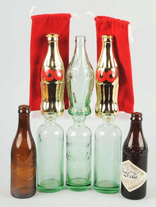 Lot of 8: Coke Commemorative & Replica Bottles.: Description Very nice overall. Condition (Excellent - Near Mint). Size Largest: 8 - 1/4" T.