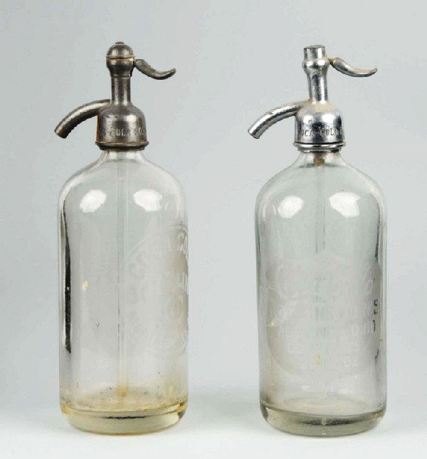 Lot of 2: Coca-Cola Seltzer Bottles.: Description 1920s to 1940s. Montgomery, AL and Alliance, OH. Light to medium wear and soiling. Condition (Very Good Plus). Size Each: 10 - 3/4" T.