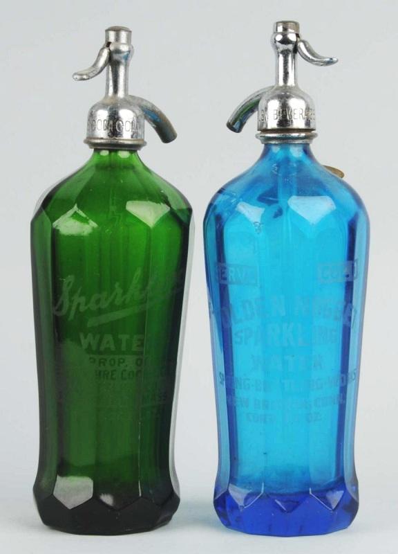 Lot of 2: Colored Coca-Cola Seltzer Bottles.: Description 1920s to 1940s. Blue bottle from New Britain, CT and green from Pittsfield, MA. Light to medium wear, small nicks, and minor marks. Condition (Very Good Plus). Size Each: 12" T.