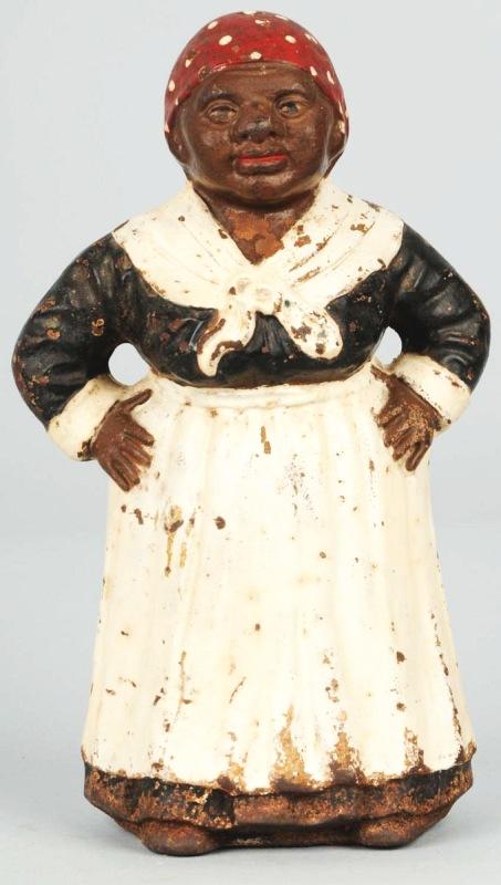 Cast Iron Mammy with Hands on Hips Doorstop.: Description Manufactured by Hubley. Touchup to paint. Condition (Good). Size 10 - 1/2" T.