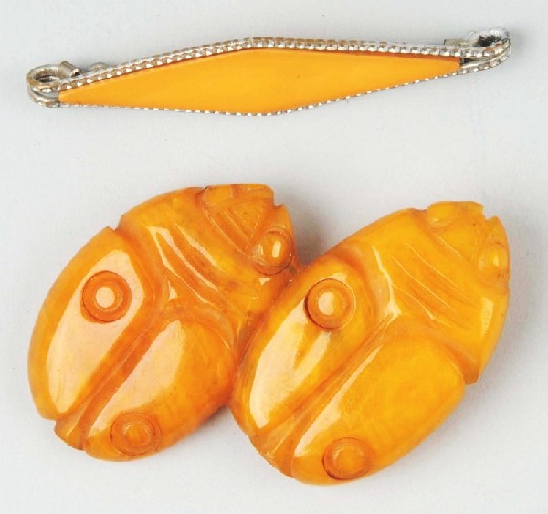 Lot of 2: Bakelite Butterscotch Pins.: Description Includes one with two beetles and one with a diamond-type pattern set in a metallic base. Condition (Excellent).