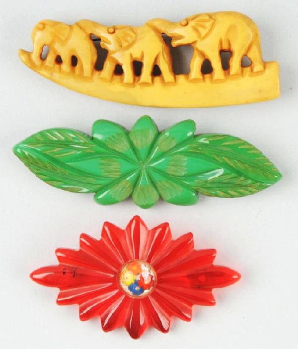 Lot of 3: Bakelite Pins.: Description Includes one green carved floral pattern, one with three elephants, and one translucent root beer. Condition (Excellent).