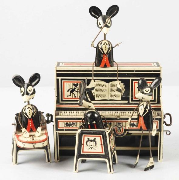 Tin Marx Merrymakers Band Wind-Up Toy.: American. Conductor variation. Complete and all original. Some scratching and wear to piano. Size: 9 - 1/2" T.