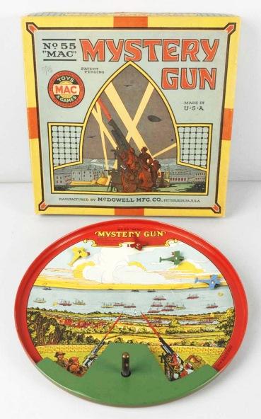 Tin McDowell Mystery Gun Toy.: WWI-era. Comes with four tin airplanes, original steel balls, and a piece of rope. Beautiful lithography on toy. Marked "No. 55 MAC Mystery Gun". Very little wear overall. Includes very colorful origi