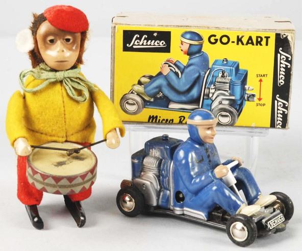 Lot of 2: Tin Schuco Toys.: German. Working. Includes Go-Kart with original box and figural Monkey Drummer. Some wear to drum. Size: Largest: 4 - 1/2" T.