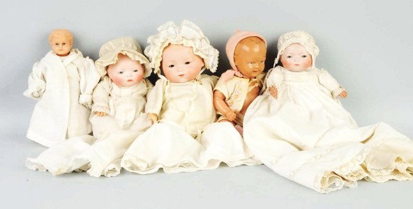 Lot of 5: Celluloid and Bisque Dolls.: 2 Bye-Lo Babies with sleeping eyes, cloth Bye-Lo bodies with celluloid hands, one with original tagged dress; celluloid baby with Indian head mark; celluloid child with turtle mark; Dream Baby A.M. 34