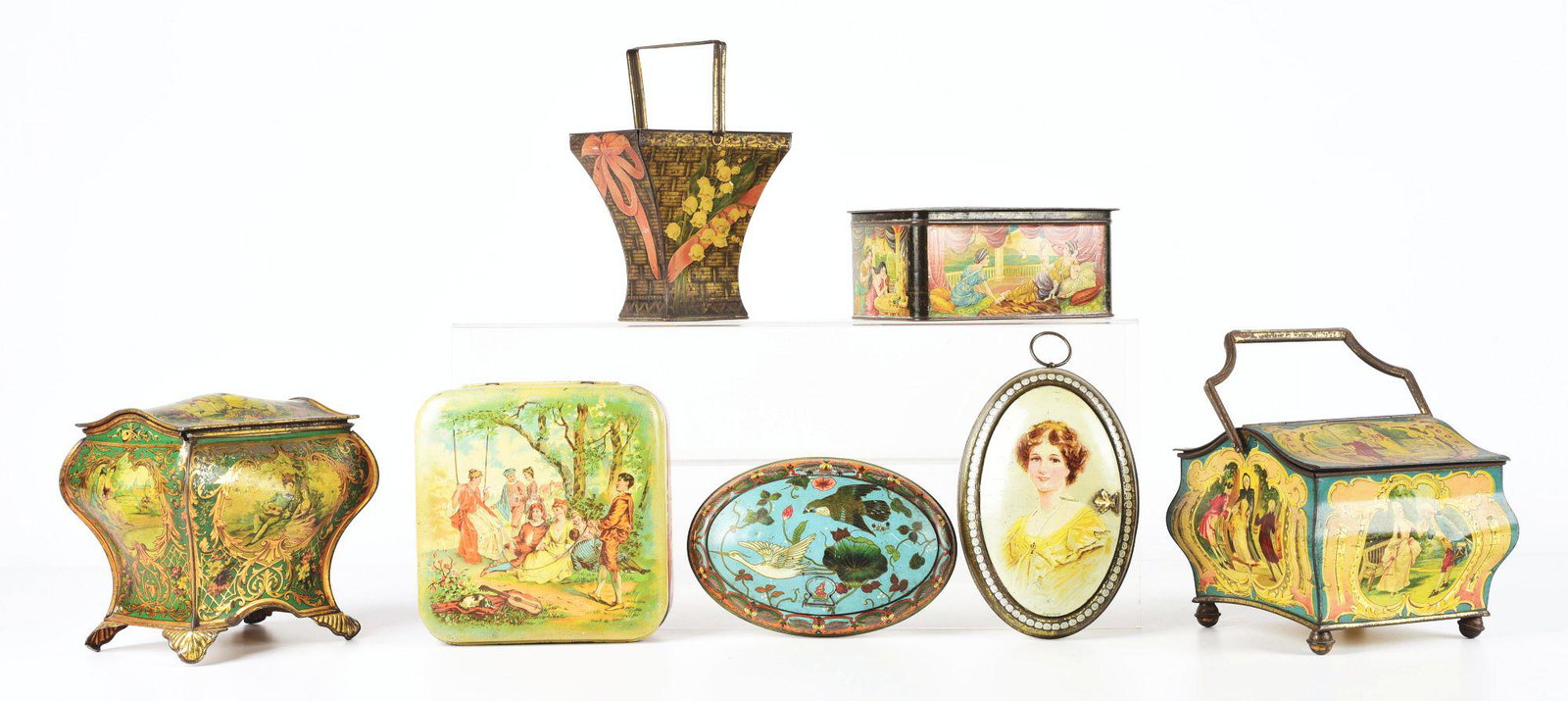 LOT OF 7: HUNTLEY & PALMER BISCUIT TINS.: Lot of seven Huntley & Palmer biscuit tins. First is Sevres, c. 1897. Second is Watteau, c. 1903, a handled casket-shaped tin with only 20,000 made. Third and fourth are both oval-shaped, Cloisonne, c