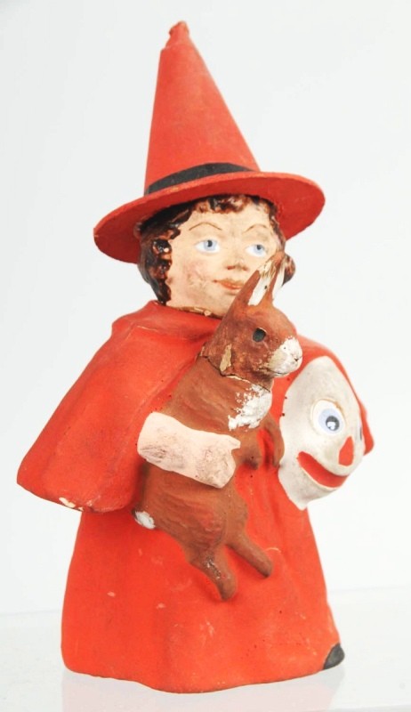 Little Red Witch Holding Ghoul Candy Container.: This candy container is a bit of an enigma, this young girl looks like Little Red Riding Hood but she has a witch's hat holding a rabbit in one arm and a ghoul in the other. A strange mix but throw it