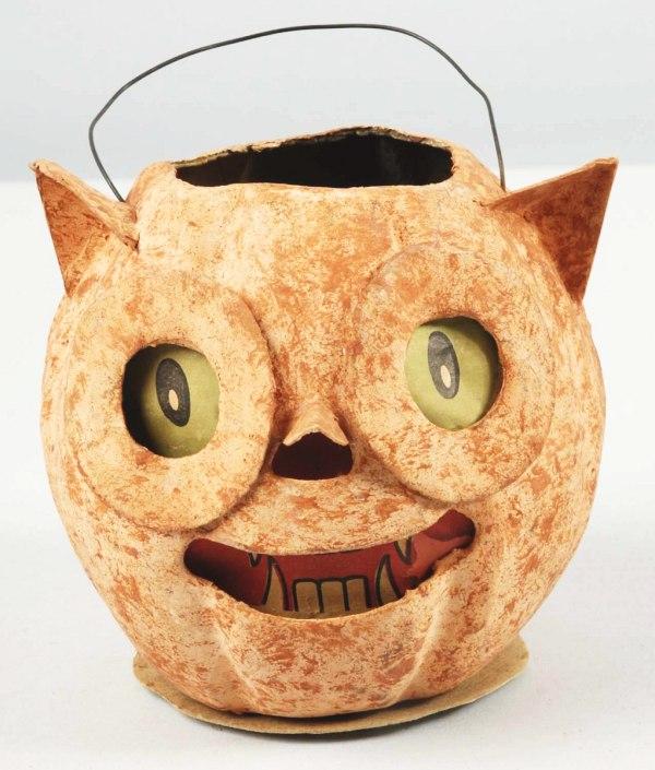 Paper Mache Owl Jack-O-Lantern.: German. Marked "Germany" on bottom. Pointed nose and ears. Original paper eyes, mouth, and nose. Original "1.50" price tag on bottom. Size: 5 - 1/4" W.