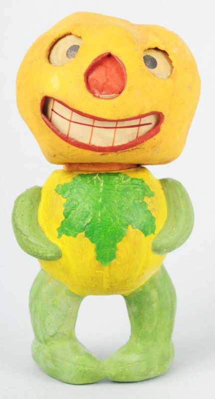 Veggie Man Jack-O-Lantern Candy Container.: Early German heavy composition. Head holds the original candle holder and paper inserts. Zucchini arms, vegetable legs, and large leaf on front. Very unusual candy container. Size: 6" T.