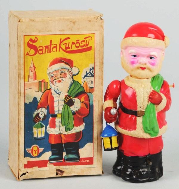 Celluloid Santa Wind-Up Toy.: Japanese. When wound, Santa moves up and down from his waist while bobbing his head and lantern. Includes original box with some soiling and minor paper loss. Size: 6" T.