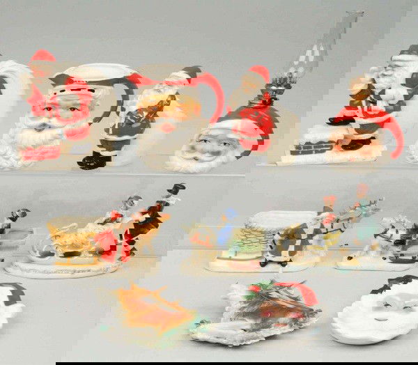 Lot of 9: China Christmas Decorations.: Includes an oil lamp, one Santa head creamer, four flower planters, and a Victorian couple on a sleigh ride. Size: