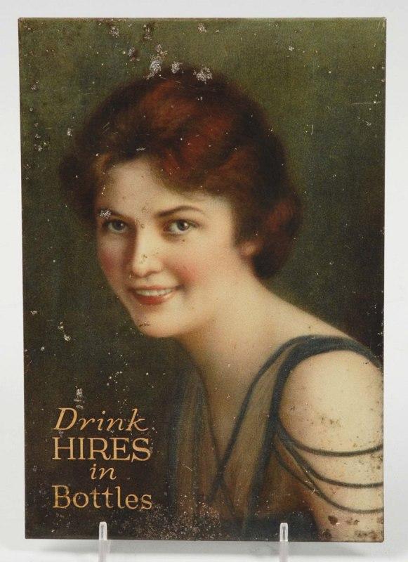 Tin over Cardboard Hires Root Beer Sign.: Some oxidation, particularly to bottom and on pretty lady's left arm. 9 - 1/4" x 6 - 1/2". (Very Good).