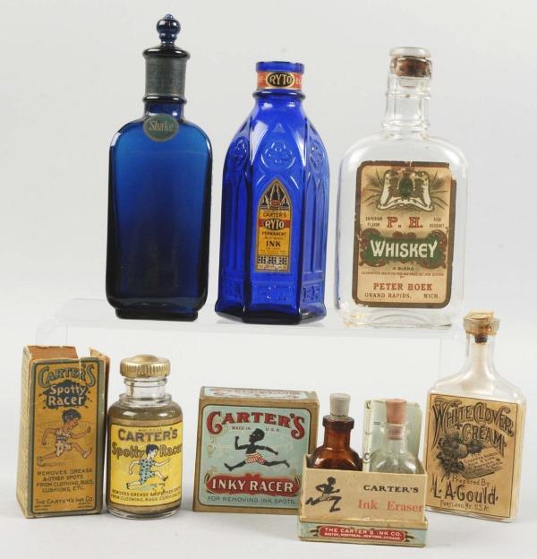 Lot of 6: Advertising Tins & Bottles.: Includes one Carter's cobalt blue ink bottle, one White Clover Cream bottle by LA Gold, one Peter Rose Whiskey bottle, one Carter's Inky Racer with two bottles inside, one Carter's Spotty Racer with p