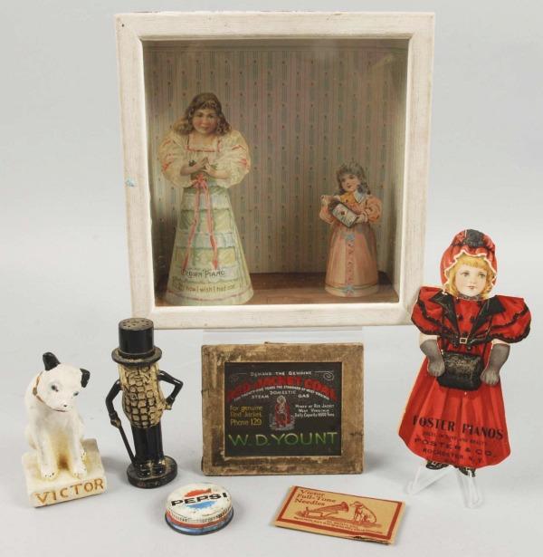 Wooden Box with Pieces of Advertising.: Includes one trade card for pianos, one Pepsi lid, one Victor needle case, one Mr. Peanut salt shaker, two rubber boots with advertising, one Victor Edison chalk dog figure, and other items. Largest: