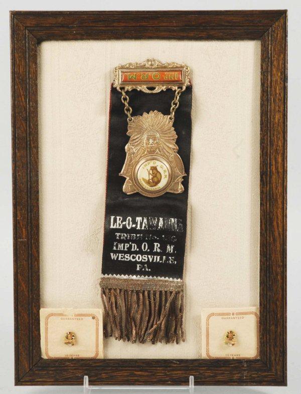 Le-O-Tawanna Indian Tribe Pin by IMP'D.O.R.M.: Early 1900s. Wescosville, PA. Depicts an Indian with celluloid beaver and two Indian pins. Framed: 11 - 1/4" x 8 - 1/4". (Excellent).