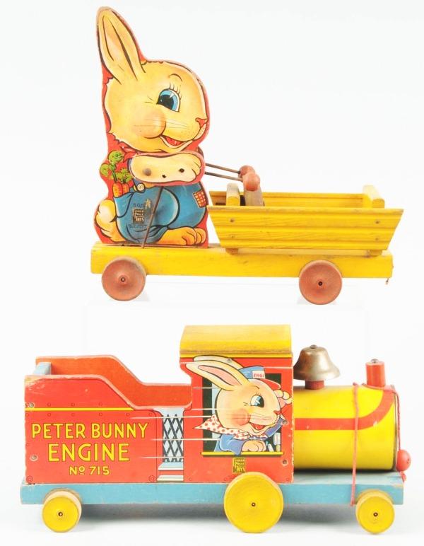 Lot of 2: Paper on Wood Fisher Price Rabbit Toys.: Includes no.505 Pull Cart and no.715 Peter Bunny Engine. When in operation, both toys rings bells. Some overall wear. Largest: 12" L. (Very Good).