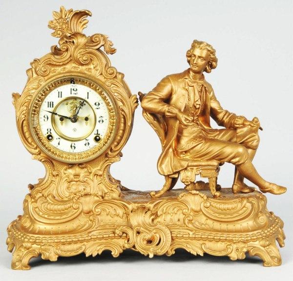 Brass Ansonia Time & Strike Clock.: Has pendulum. Features a man sitting in chair. 15" x 15". (Excellent).
