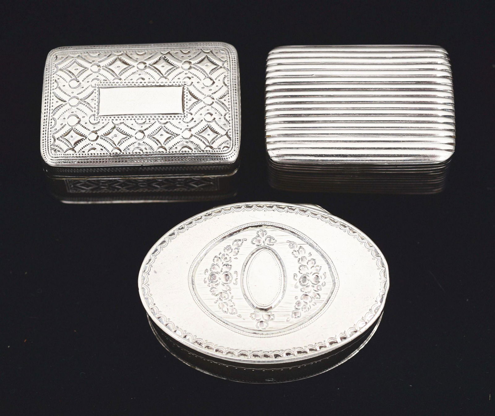 THREE ENGLISH SILVER NUTMEG GRATERS.: The first, Phipps & Robinson, London 1795, oval with straight sides, the top engraved with an oval reserve; the second, Joseph Willmore, Birmingham, rectangular with a hinged base, lacking date letter