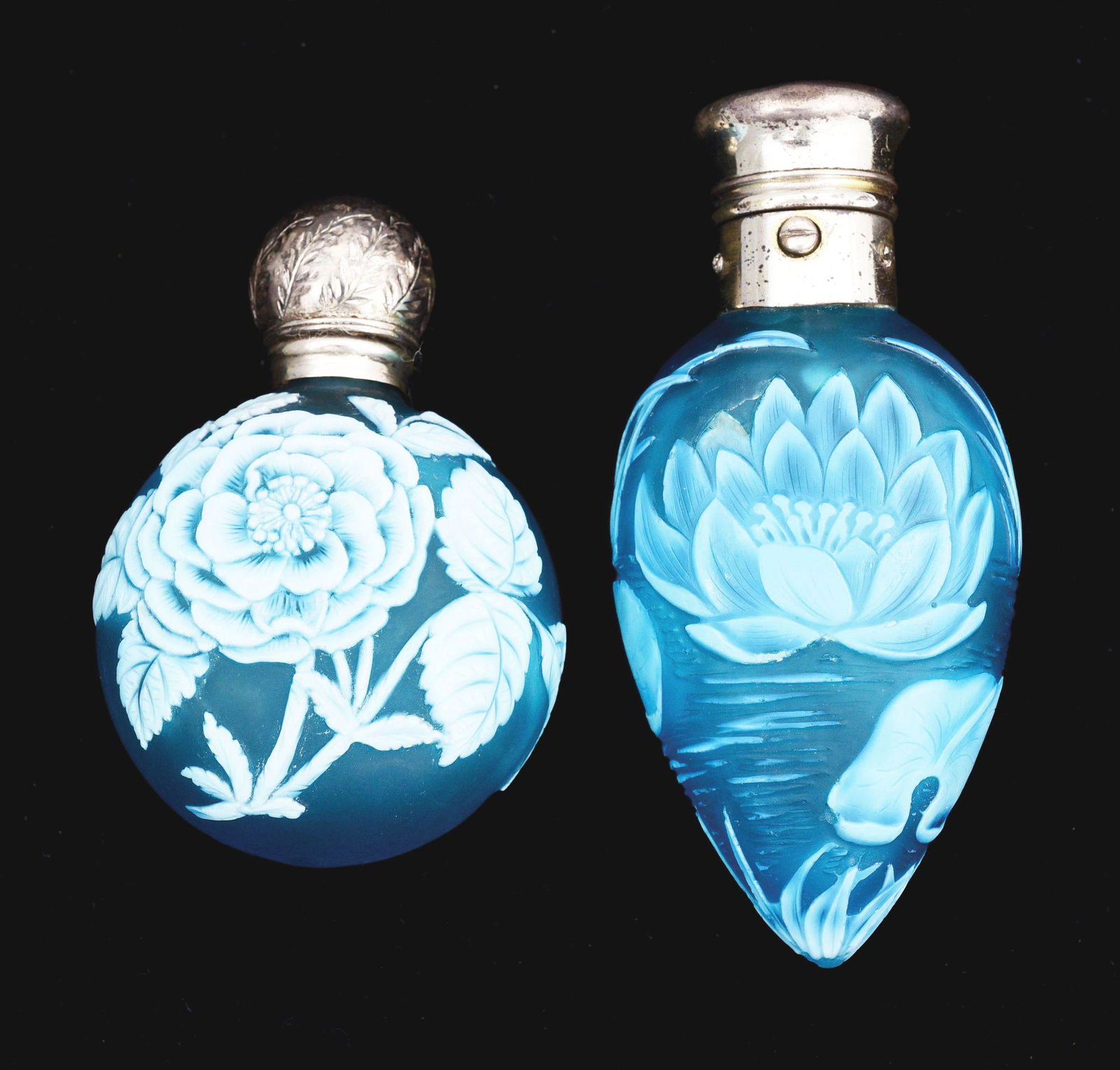 LOT OF 2: CAMEO GLASS PERFUME OR SCENT BOTTLES.: Lot of two Cameo glass perfume or scent bottles, probably by Thomas Webb. The first is with floral design on front and two butterflies on back, with glass stopper and hinged silver top. 2 - 1/2" T. Th