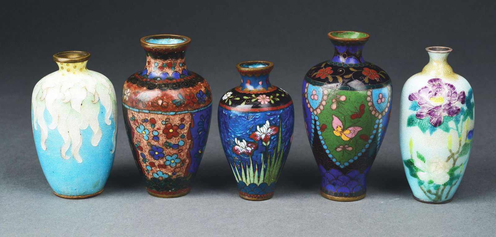 LOT OF 5: JAPANESE MEIJI PERIOD (1868-1912): The first is a highly iridescent vase with blue and white drippings. 3 - 1/2" tall. The second is a highly iridescent vase with white and embossed flowers. 3 - 3/4" tall. Slight stain to back. Both th