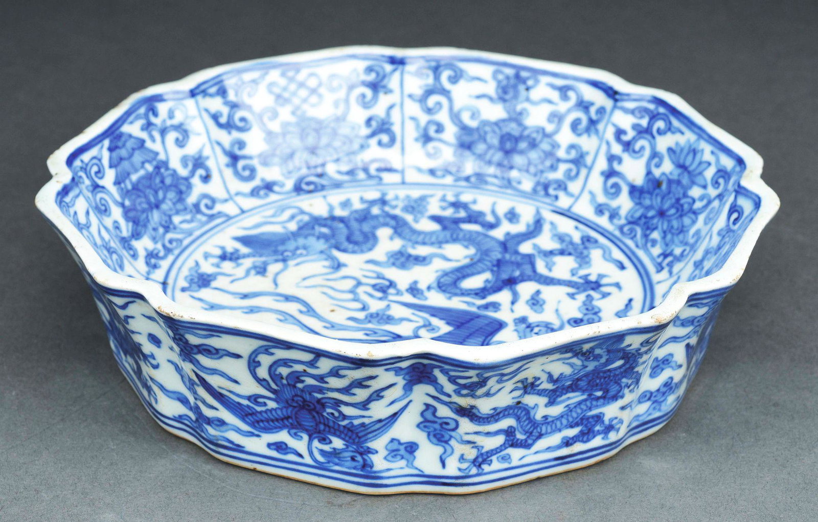 QING DYNASTY BLUE AND WHITE DRAGON BOWL.: A Qing Dynasty blue and white dragon pattern bowl with scalloped rim and a mark to base. No scratches, chips, cracks or damage. Condition: (Excellent). Dimensions: 8"D x 2"T.