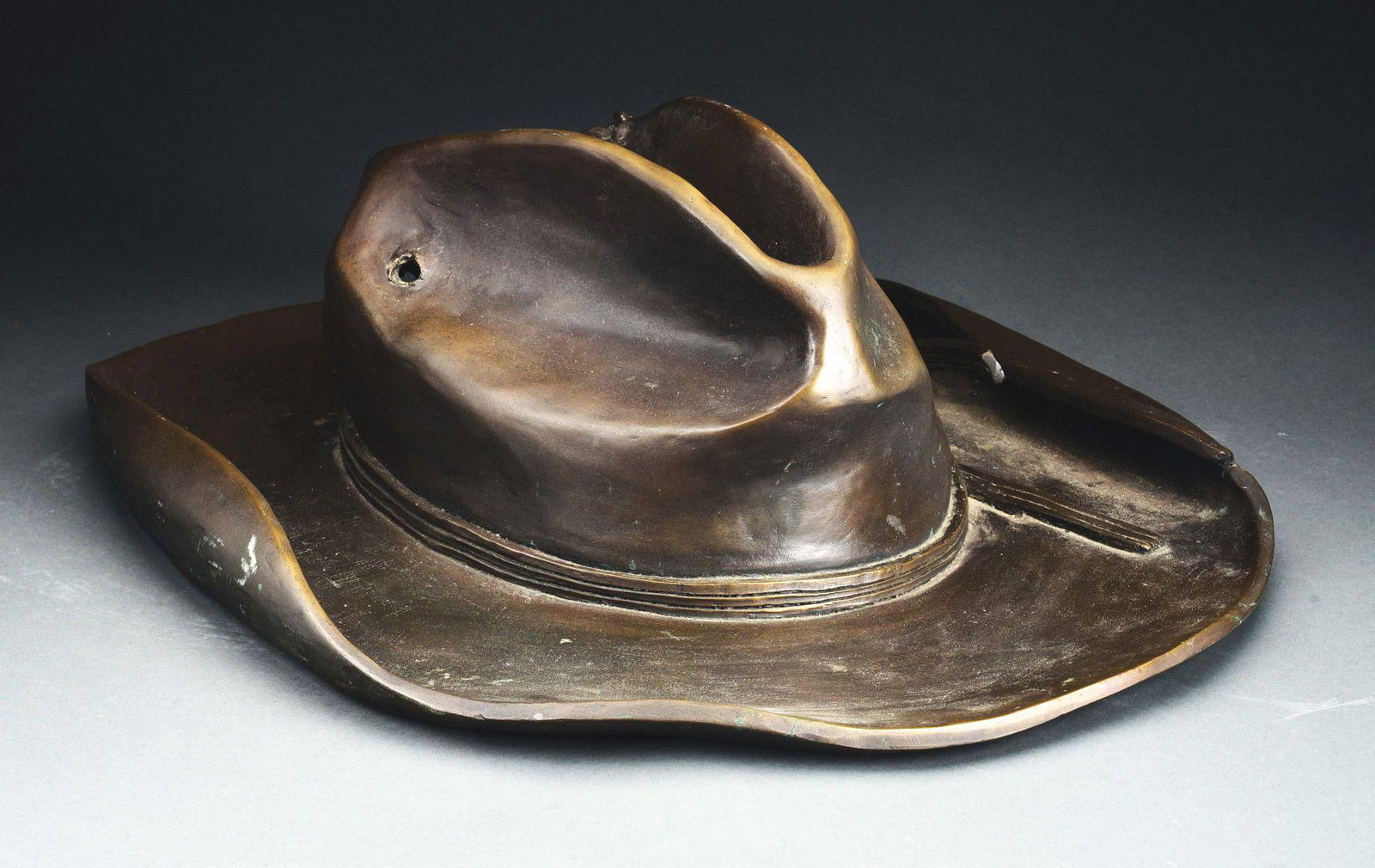 OVERSIZED BRONZE COWBOY HAT. (1 of 4)