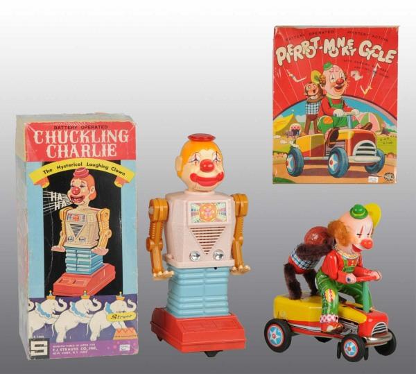 Lot of 2: Tin Litho Clown Battery-Op Toys in O/B: Japanese. Working. Includes one Chuckling Charlie and one Pierot Monkey Cycle. Includes both original boxes with great circus graphics. Largest: 13 - 1/4" T. (Excellent).