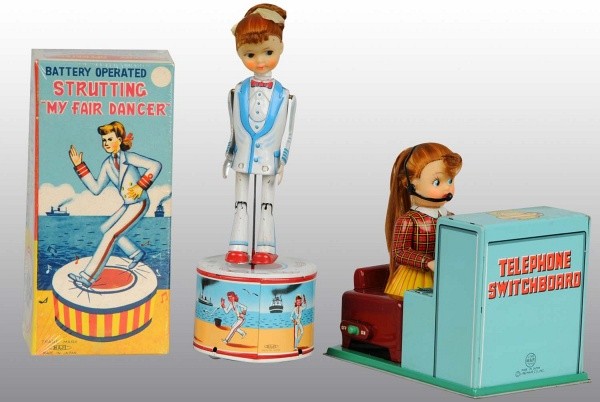 Lot of 2: Tin Litho Female Battery-Op Toys.: Japanese. Working. Includes one Strutting My Fair Dancer toy and one Telephone Switchboard Operator toy. Very little wear overall. Includes one original box for the Dancer toy. Largest: 11" T. (Excell