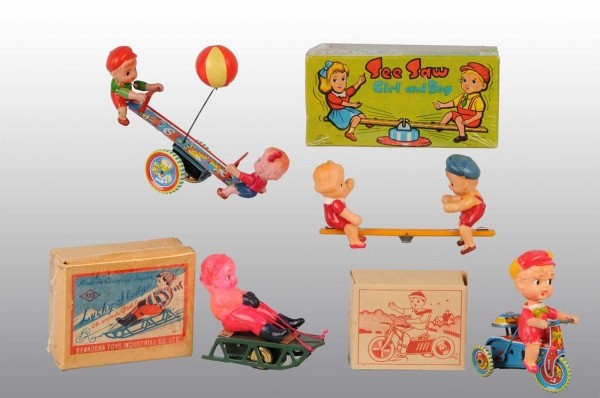 Lot of 4: Celluloid Children Wind-Up Toys.: Japanese. Working. Includes one boy on sled, one boy on tricycle, and two see-saw toys. Very little wear overall. Includes three original boxes. Largest: 7 - 1/2" L. (Excellent).